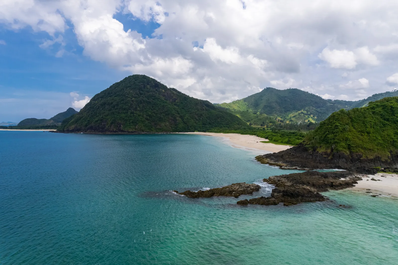 Aerial photograph of a Lombok bay framed by green headlands